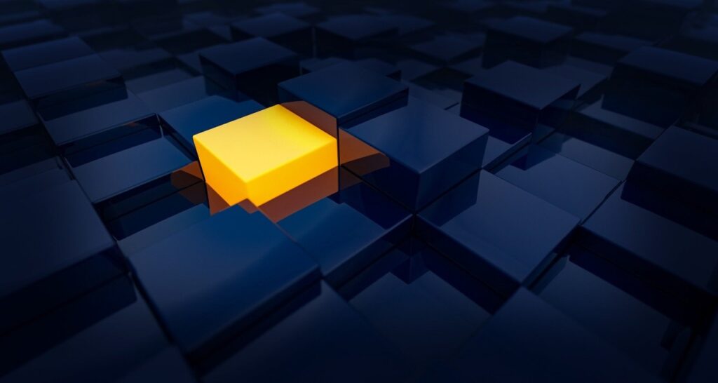 yellow cube among black cubes