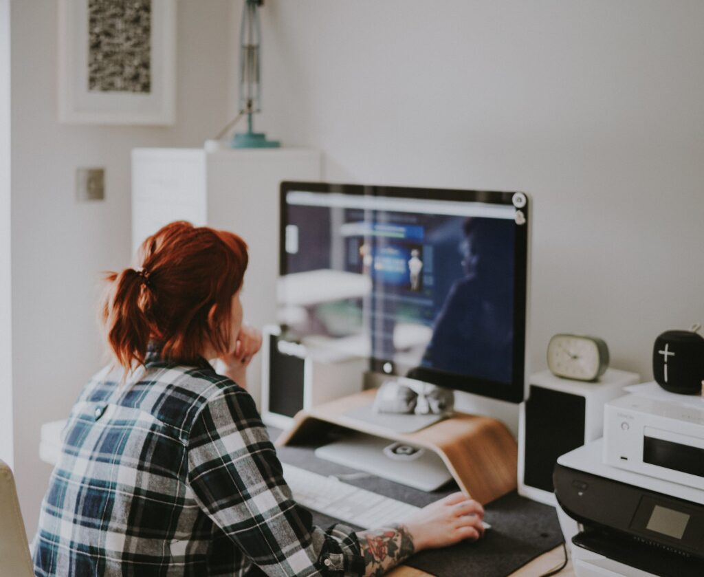 a person sitting in front of the computer screen