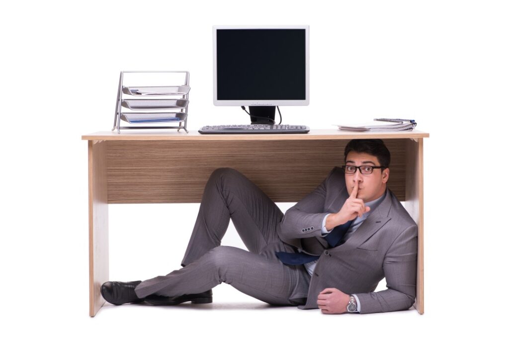 man hiding under the table