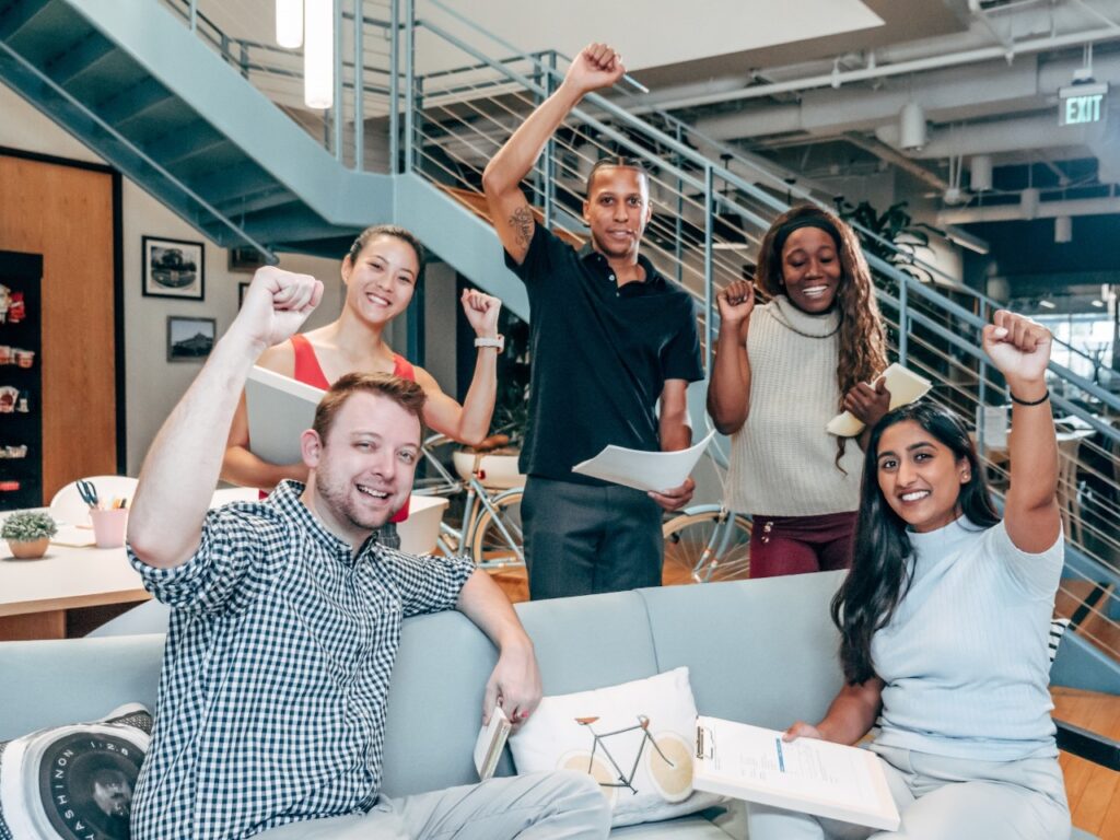 people cheering and raising a fist